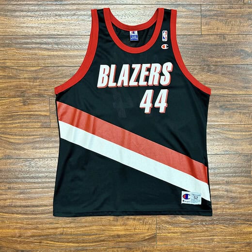 Front view of vintage Brian Grant Portland Trail Blazers Champion jersey with red trim and number 44 on a black, red, and white design.